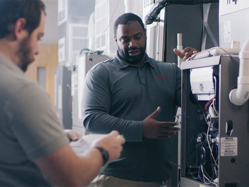 Men looking at the inside of a new furnace